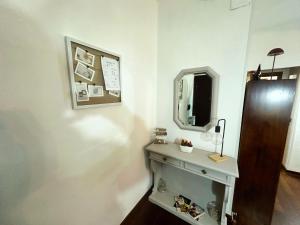 a bathroom with a sink and a mirror on a wall at La casa di Fred in Rome