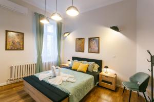 a bedroom with a bed with towels on it at Klimt's Puzzle Suite in Sofia