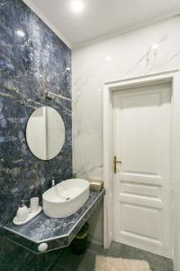 a bathroom with a sink and a mirror at Klimt's Puzzle Suite in Sofia +27 photos