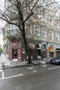 a tree on the side of a street in front of a building at Klimt's Puzzle Suite in Sofia