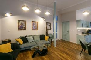 a living room with a couch and a table at Klimt's Puzzle Suite in Sofia