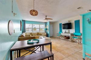 a living room with a couch and a table at Seas the Day in Navarre