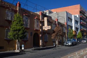 a street with a building with a sign on it at OYO Hotel Colón, Plaza Bicentenario, Zacatecas Centro in Zacatecas