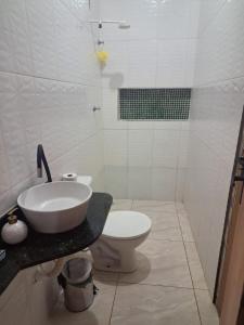 a bathroom with a sink and a toilet at Doce Lar 58- Casa Evento in Cabo de Santo Agostinho +2 photos
