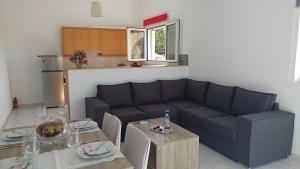 a living room with a couch and a table at Eva's House in Kissamos
