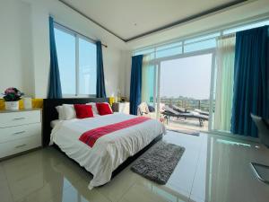 a bedroom with a large bed and a large window at Sea View Luxury Mansion, Pool & Jacuzzi - Koh Chang in Ko Chang