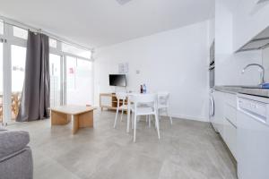 a kitchen and living room with a table and chairs at Puerto Amatista 1 in Puerto del Carmen