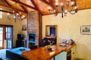 a kitchen with a wooden counter top in a room at Stonehaven Cottage in Machadodorp