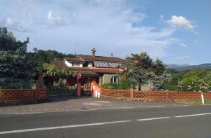 a house with a fence next to a road at Villa Carla in Filattiera