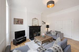 a living room with a couch and a fireplace at Large Luxury City Centre Flat with Balcony in Bristol