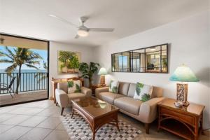 a living room with a couch and a table at Kihei Beach, #603^ condo in Kihei