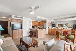 a living room with a couch and a kitchen at Kihei Beach, #603^ condo in Kihei
