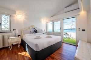 a bedroom with a large bed and a large window at Valerie Luxury House And Spa in Zoagli