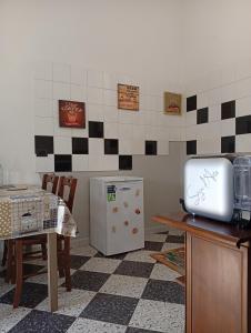 a kitchen with a table and a refrigerator at Villa Carla in Filattiera +15 photos