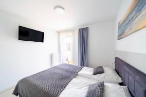 Postel nebo postele na pokoji v ubytování APARTAMENT PRZY WYDMIE