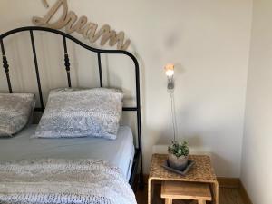 a bedroom with a bed and a table with a lamp at 'tMaelhof in Voeren