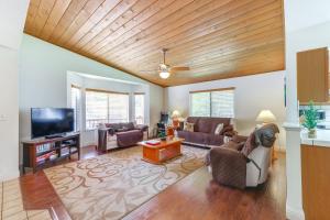a living room with couches and a flat screen tv at Mountain Paradise about 1 Mile to Pine Mountain Lake! in Groveland