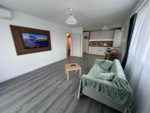a living room with a couch and a table at Myhouse 2 in Ploieşti