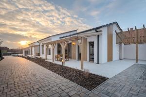 a rendering of a building with a sunset in the background at HelloHal Házak in Tiszafüred
