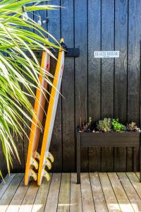 a sign on a fence next to a wooden deck at Beach House in Lège-Cap-Ferret
