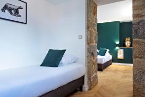 a bedroom with two beds with green walls at Maison Philippe Le Bon Hôtel, Restaurant & Bar le 19 in Dijon +89 photos