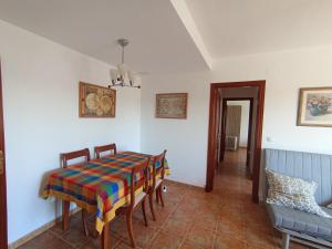 a dining room with a table and chairs at Carpe Diem Bosque in El Bosque
