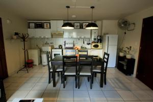 a kitchen with a table and chairs in a room at Alquiler Temporario Departamento Pucará Jujuy in San Salvador de Jujuy
