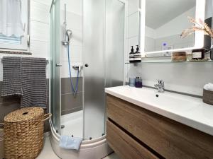 a bathroom with a sink and a shower at Apartments Terra Solaris in Medulin