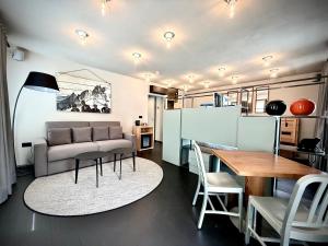 a living room with a couch and a table at Hotel Village in Aosta