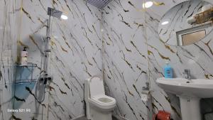 a bathroom with a toilet and a sink at Hotel Registon Zargaron in Samarkand +40 photos