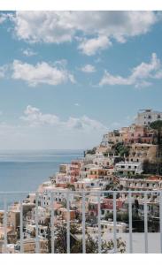 a group of houses on a hill next to the ocean at La Pigolina in Positano +20 photos