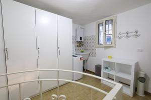 a white bathroom with a glass shower backdoor at Casa Indaterr in Mola di Bari +40 photos