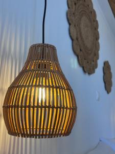 a brown pendant light hanging from a ceiling at The Anafians Studios in Anafi