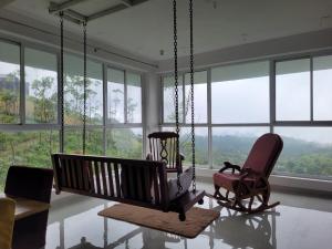 a room with two chairs and a swing at Ameliore Horizon Luxe in Pīrmed