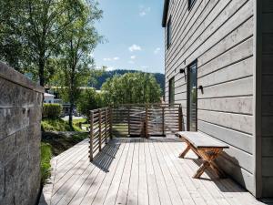 a wooden deck with a bench next to a building at Ski lodge Åre by in Åre