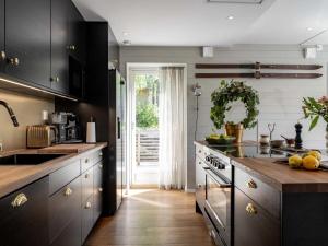 a kitchen with a sink and a stove top oven at Ski lodge Åre by in Åre