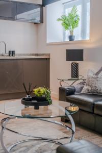 a living room with a glass table and a couch at Union Row Retreat - SJA Stays - Luxury 1 Bed Apartment in Aberdeen