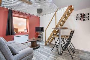 a living room with a couch and a ladder on the wall at La Casa Dorée in Charnay