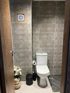 a bathroom with a white toilet in a stall at Kénitra centre ville Mimosa in Kenitra