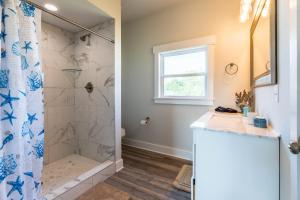 a bathroom with a shower and a sink at Stunning Sunset, Close To Beach Access, Great Views! in Surf City