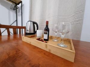 a wooden tray with wine bottles and glasses on a table at The Garden House in Paradisi in Paradeísion +5 photos