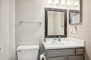 a bathroom with a sink and a toilet and a mirror at 3001 Crystal Springs 721 I Spacious 2 Bed 2 Bath in Bedford +8 photos