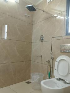 a bathroom with a shower and a toilet in it at Misty Rosa Resorts Pvt Ltd in Kottayam