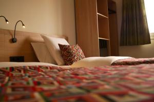 Letto o letti in una camera di Hotel-Restaurant Stand'Inn