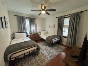a bedroom with two beds and a ceiling fan at Tulsa Home Sweet Home - King Bed Near Expo, TU, Dtwn in Tulsa
