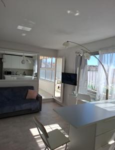 a kitchen and living room with a couch and a table at Macé9 in Cannes