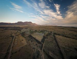 an aerial view of a town in a desert with a mountain at Dwarsvlei Guest Farm in Middelburg