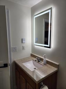 a bathroom with a sink and a mirror at Nautical Mile Resort in Wells