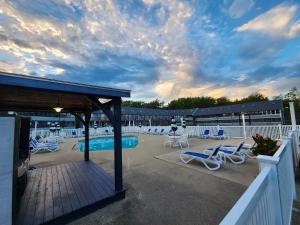 a deck with lounge chairs and a swimming pool at Nautical Mile Resort in Wells