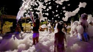 a group of people standing in a bed of foam at La Mimosa Camping in Fano +75 photos
